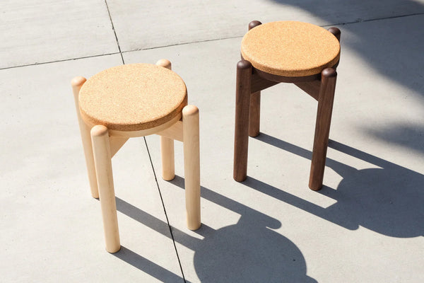 Pesä stool side view showing hand-turned solid wood legs