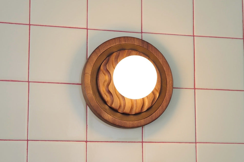 Eddy wall sconce turned on showing warm dimmable light in bedroom