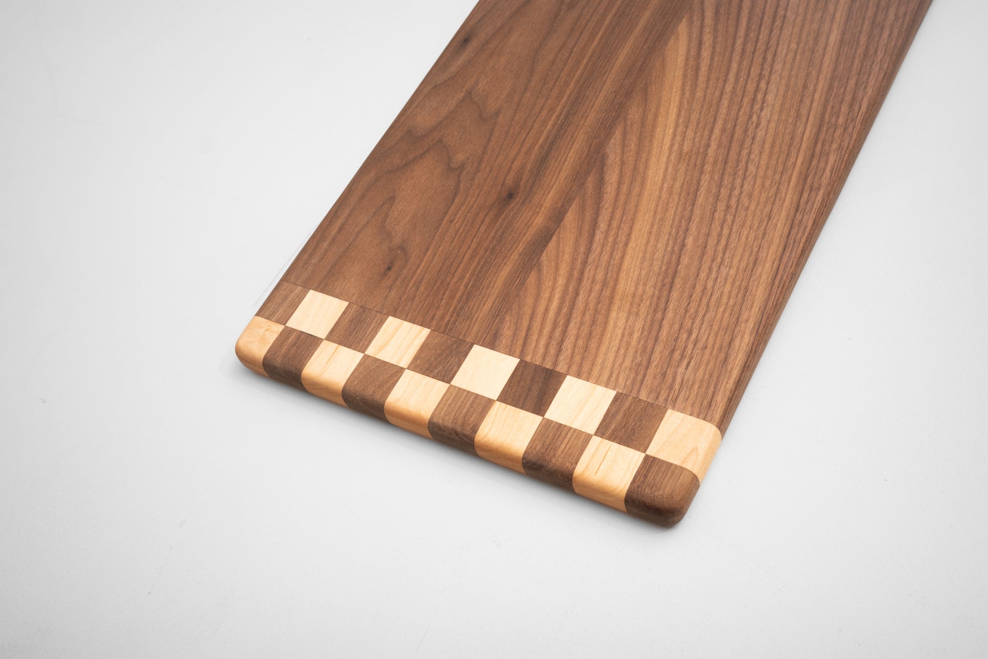 Handcrafted hardwood cutting board checkered pattern detail