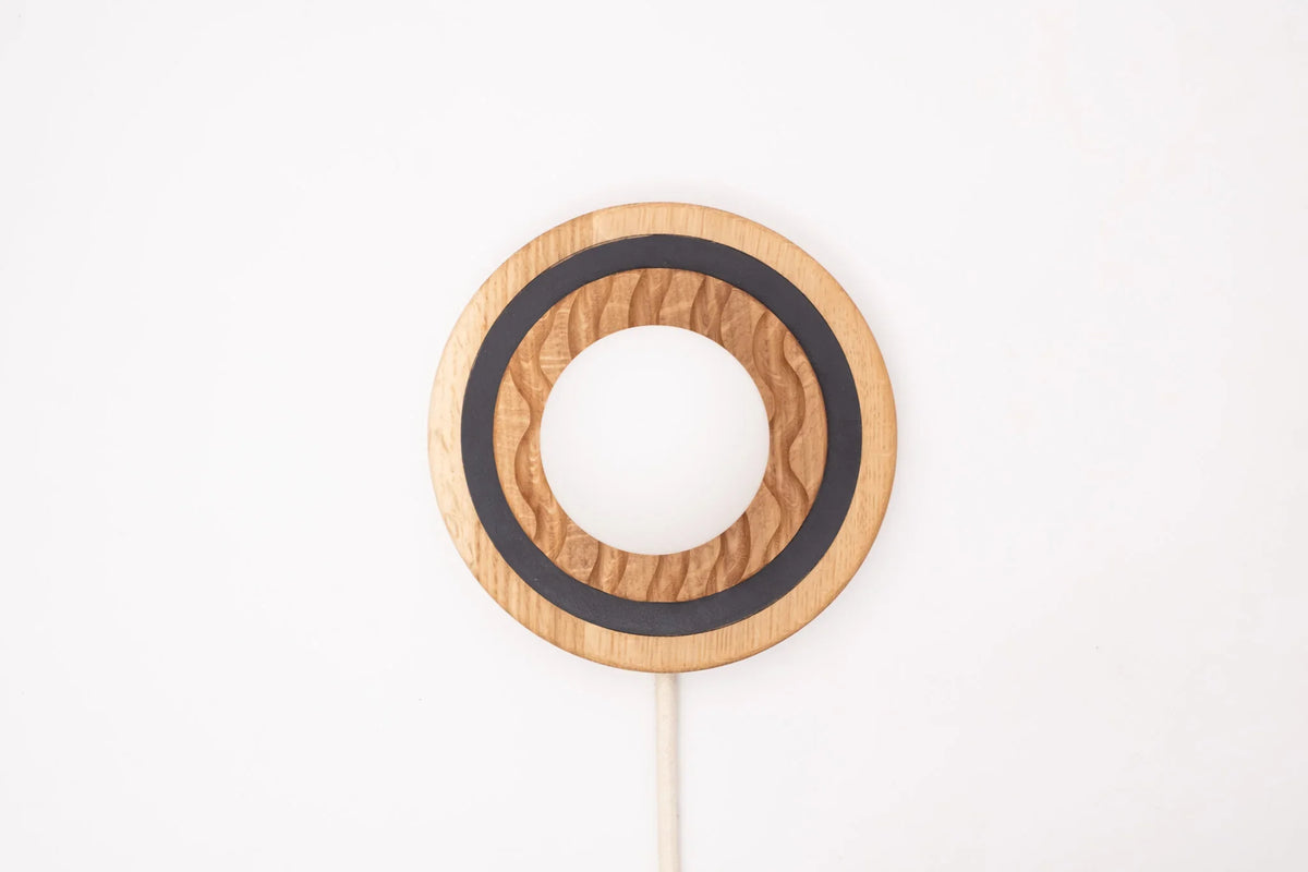 Eddy sconce detail showing leather accent and wood grain