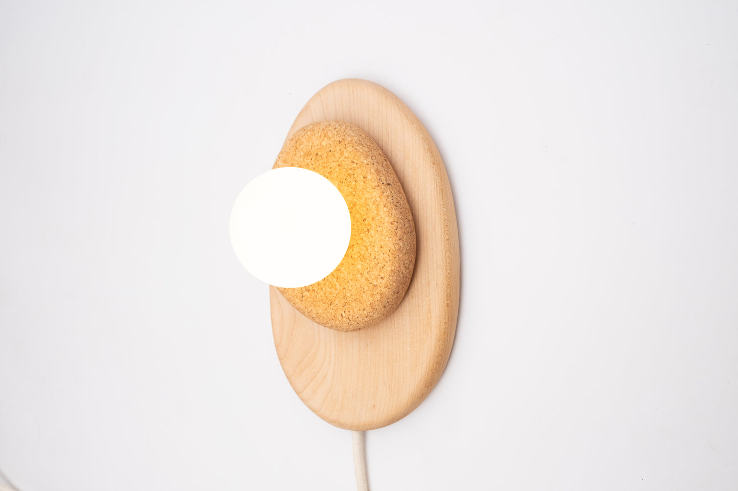 Pebble plug in wall sconce