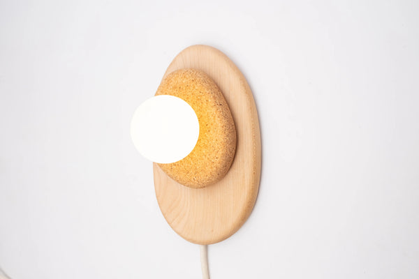Handcrafted walnut wall sconce with cork shade detail