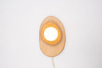 Pebble plug in wall sconce