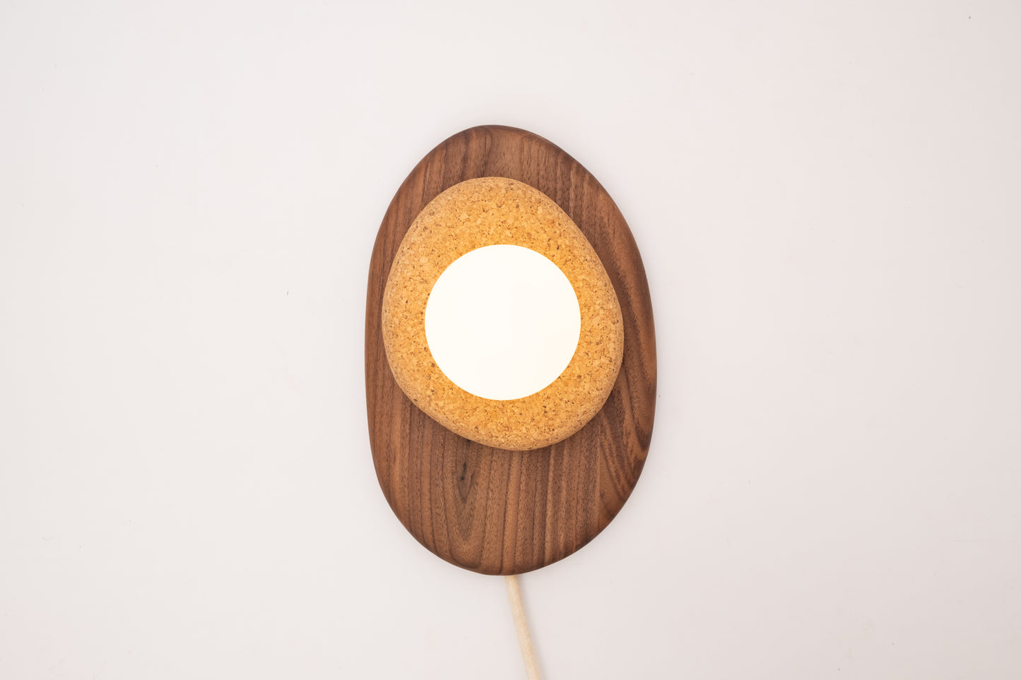 Pebble plug in wall sconce
