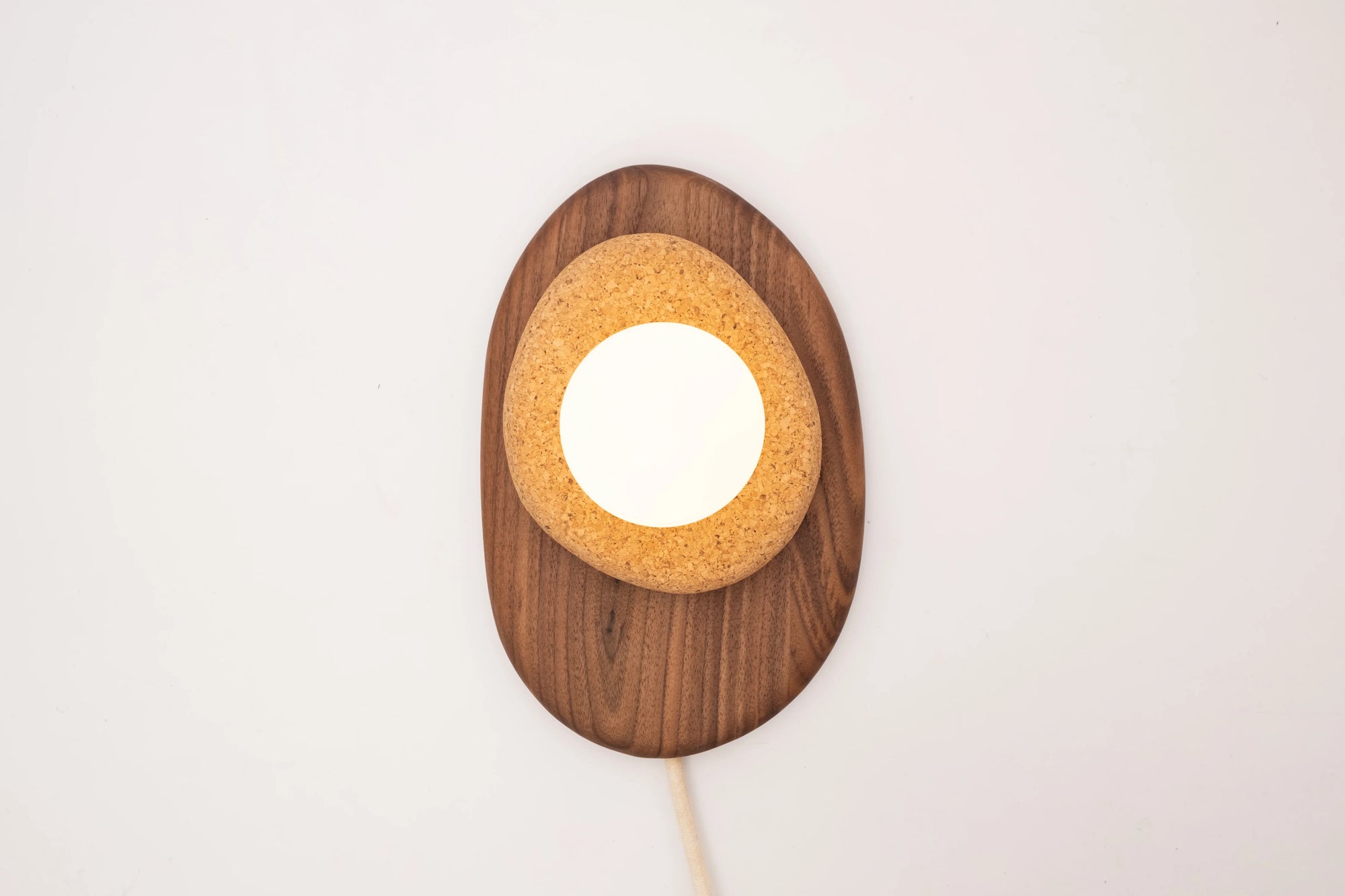 Pebble plug in wall sconce