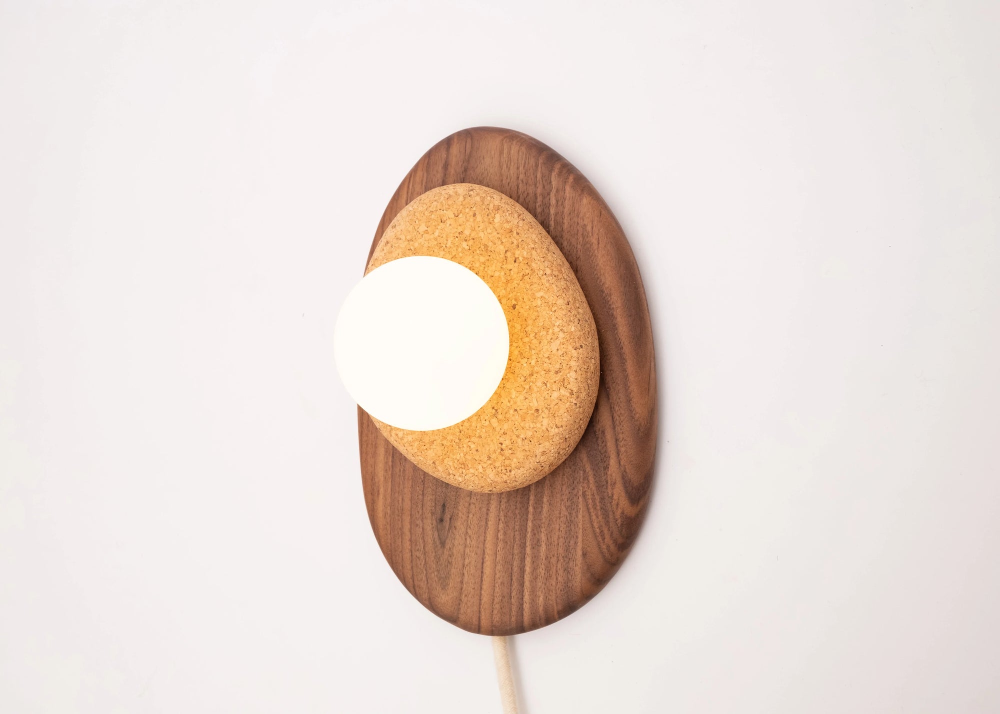 Pebble plug in wall sconce