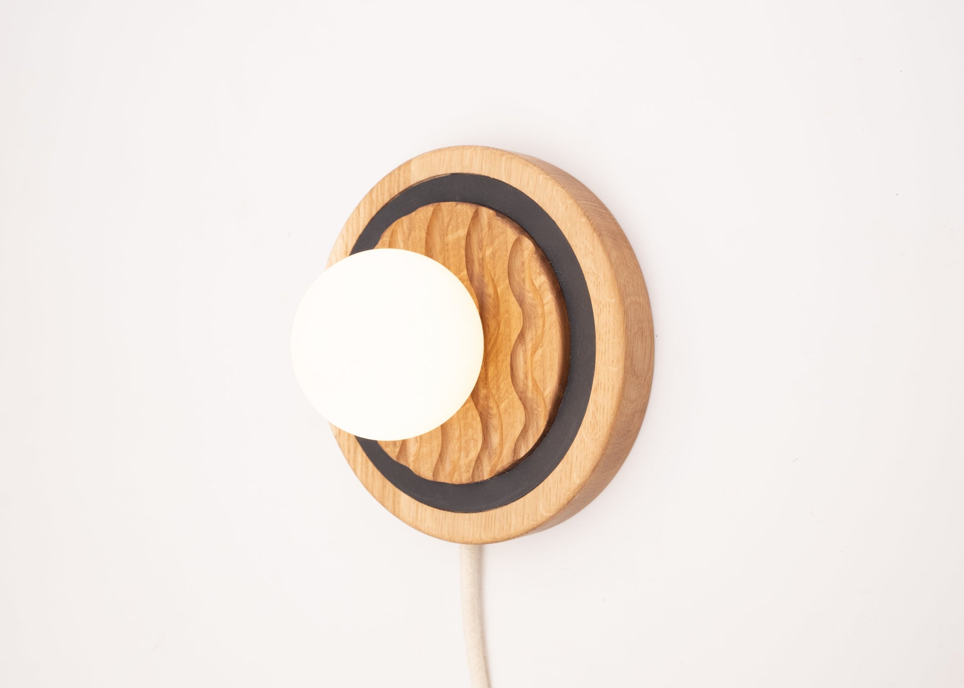 Eddy wall sconce