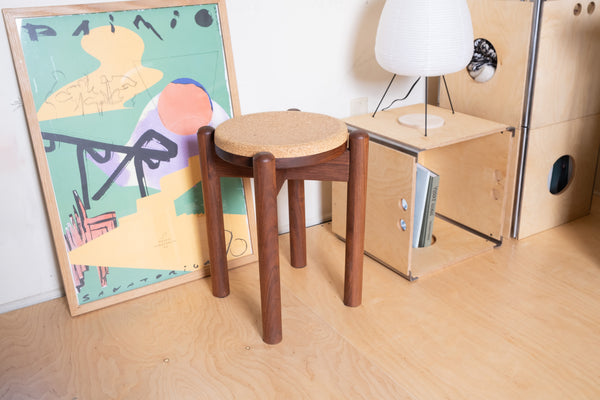 Handcrafted cork stool detail showing wood grain and cork seat