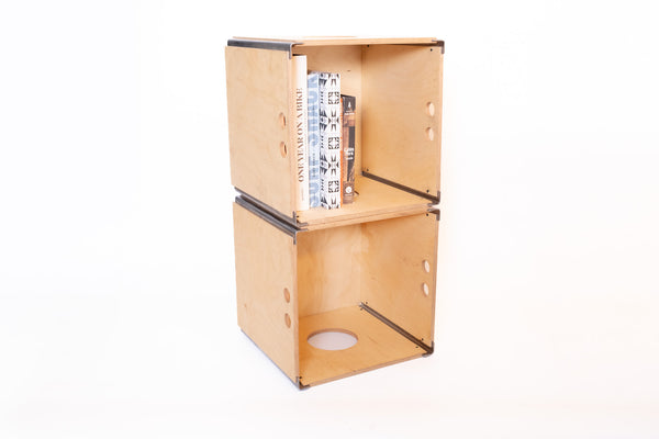 Solid birch storage crate holding vinyl records beside turntable
