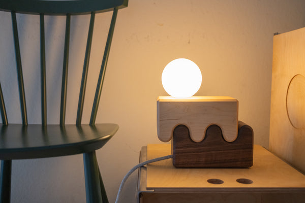 Handcrafted wood table lamp with layered curved form