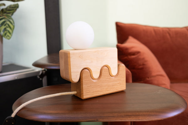 Canyon table lamp detail showing wood grain and fabric wrapped cord