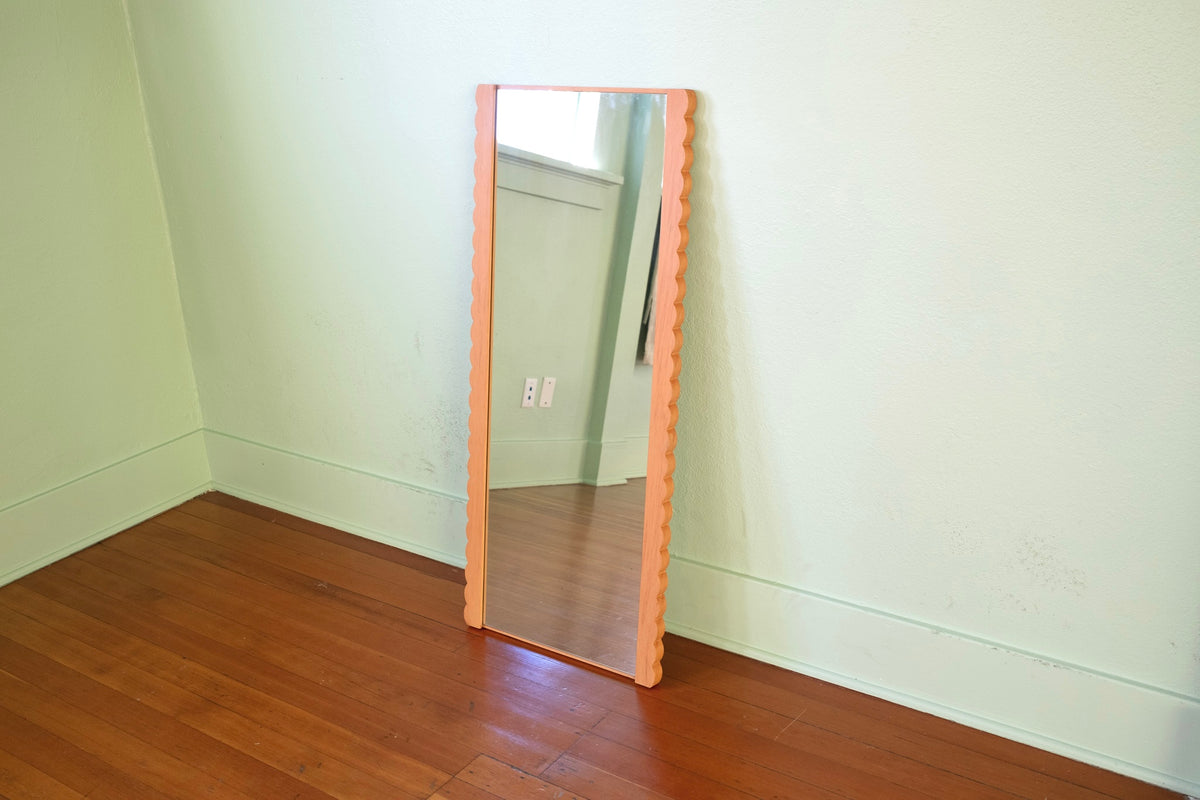 Scallop frame mirror detail showing wood grain and scalloped edge