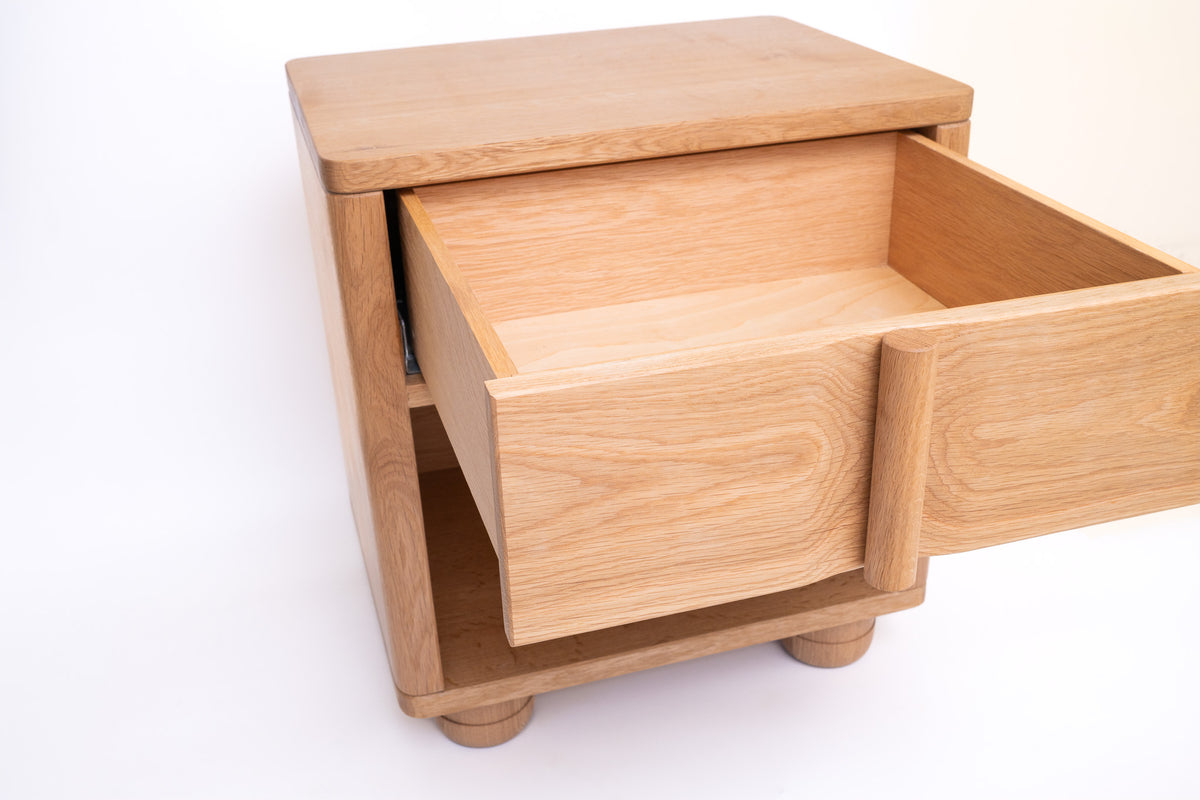 Solid oak nightstand with hand-turned legs in Japandi bedroom