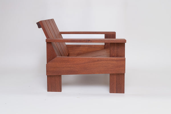 Facet lounge chair side view showing deep seat and solid wood joinery