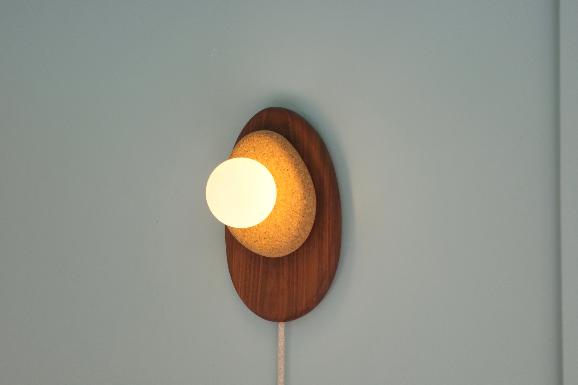 Pebble plug in wall sconce