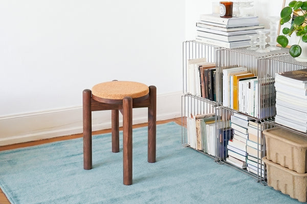 Cork seat stool used as side table in modern minimalist living room