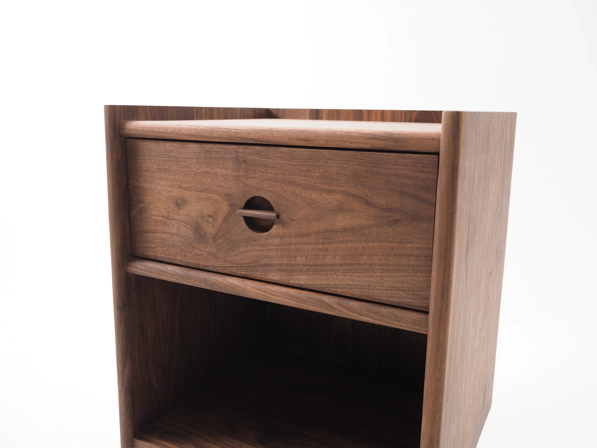 Arco nightstand drawer detail showing Arcosanti-inspired joinery